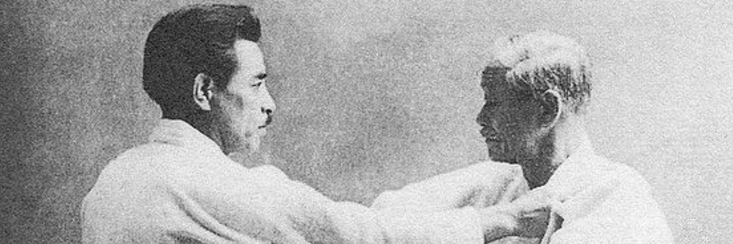 Ein altes schwarz und weiß Foto von zwei Judoka.